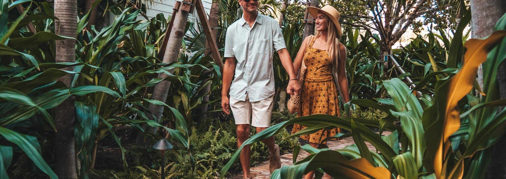 couple walking along bungalow path