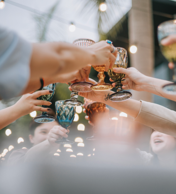 Group of people cheering their drinks