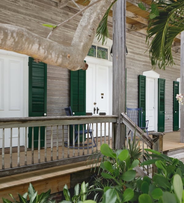 porch with white and green doors