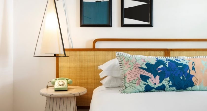 king bed with decorative pillow and phone