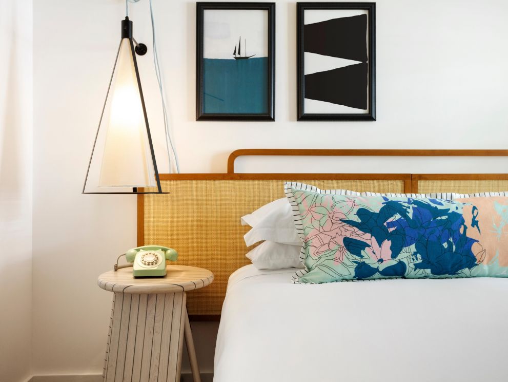king bed with decorative pillow and phone